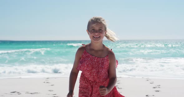 Girl standing on the beach and looking at camera