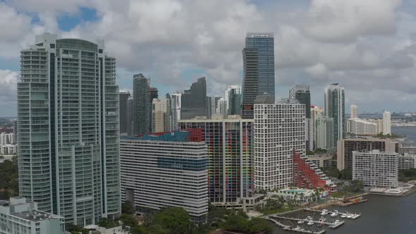 Aerial mid building heighting from inside downtown Miami towards the bay