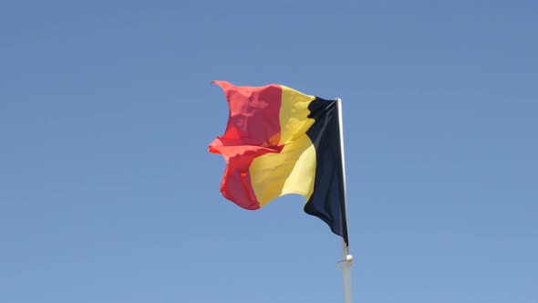 Flag of  Belgium tricolour stripes against blue sky waving 4K 2160p 30fps UltraHD footage - On wind 