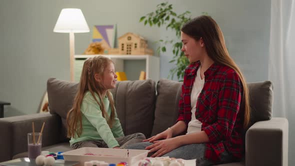 Elder Sister Discusses with Girl Easter Eggs Coloring