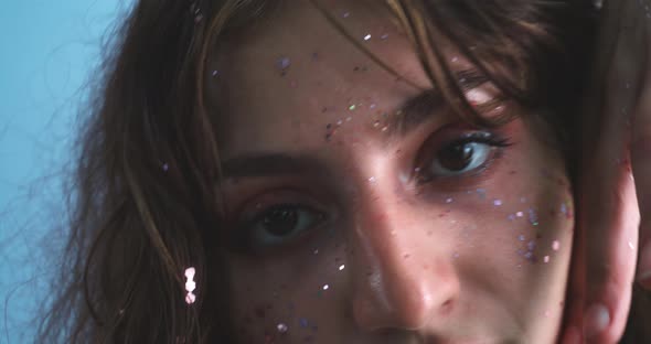 Close up of a girl dancing with her face covered of glitter