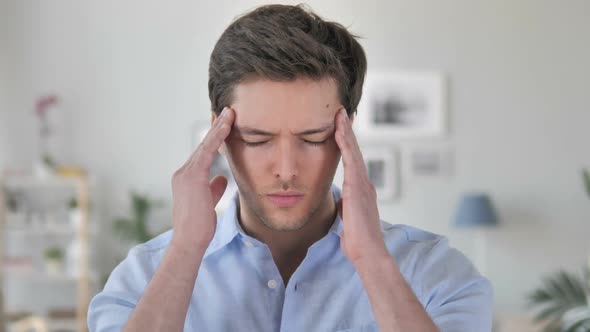 Headache Portrait of Tense Handsome Young Man in Office