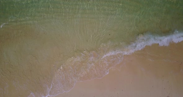 Beautiful fly over abstract shot of a sunshine white sandy paradise beach and blue ocean background 