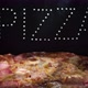 Delicious Fresh Italian Pizza On A Black Background With  The  Effect Of Light Inscription Pizza - VideoHive Item for Sale