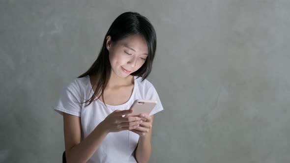 Woman listen to music on cellphone at outdoor