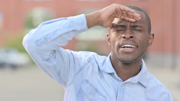 Outdoor Portrait of Curious African Man Searching for Opportunities