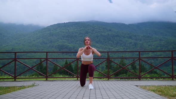 Woman Athlete Working Out Against Mountain Landscape