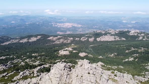 Circle with the drone in Sardinia's mountain landscape over Monte Limbara