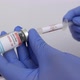 Nurse with blue gloves filling covid-19 vaccine in injection - VideoHive Item for Sale