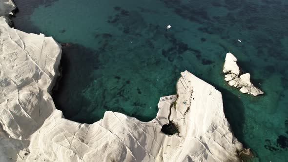 Breathtaking white cliffs tower over vibrant turquoise blue waters in the Mediterranean. Summertime