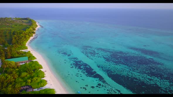 Aerial flying over landscape of paradise shore beach voyage by clear lagoon with white sand backgrou