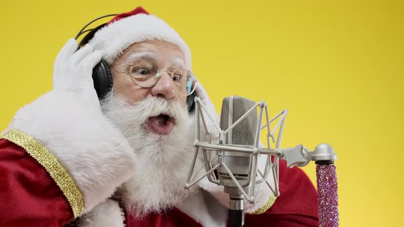 Santa Claus singing or speaking in a studio microphone. Merry Christmas