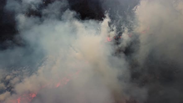 Aerial footage of wildfire on the field burning dry grass