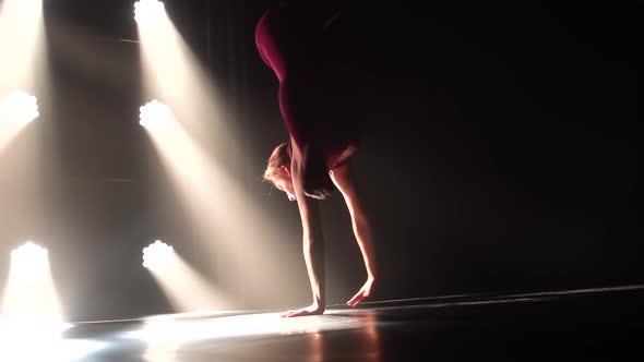 Bottom View. Graceful Rhythmic Gymnast Is Training in the Studio Performing Acrobatic Exercises