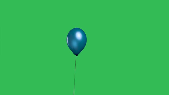 Blue Balloon Hanging in the Air Against the Background of a Green Screen Chroma Key