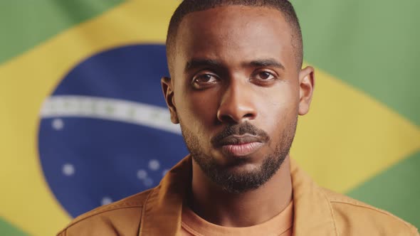 Portrait of Young Black Man against Brazilian Flag