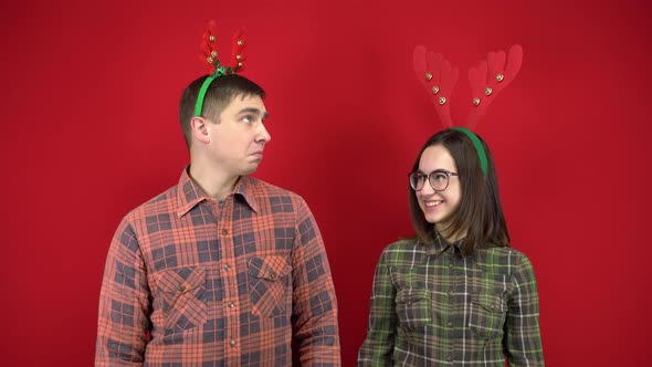 A Young Woman Laughs at a Young Man Because He Has Small Horns, and the Man Is Offended and Cries