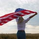 Patriotic Young Woman Holds the US Flag and Runs Across the Field - VideoHive Item for Sale