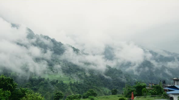 A Foggy Mountain Landscape in Nepal with the Glimpse of its Suburban Life