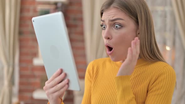 Portrait of Young Woman Feeling Shocked on Tablet in Bed 