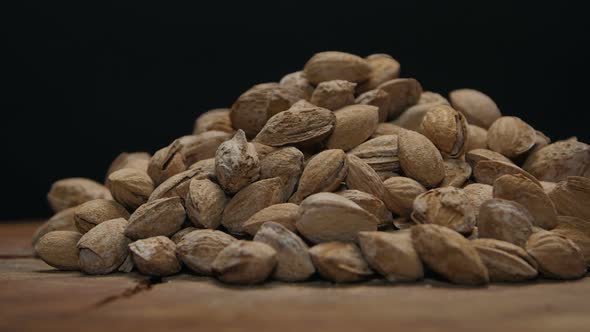 Pile Of Almonds In Shell On A Wooden Table