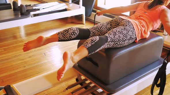 Woman exercising on gym equipment