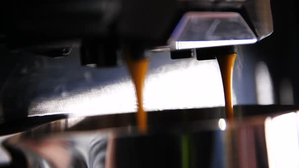 Macro Professional Coffee Machine Pours Out Latte at Bar