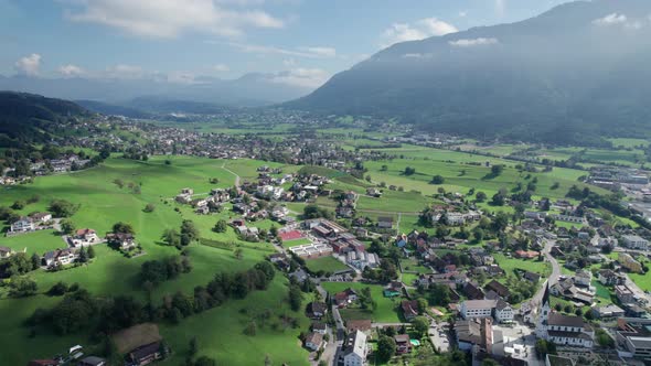 Aerial View of Liechtenstein with Houses on Green Fields in Alps Mountain Valley