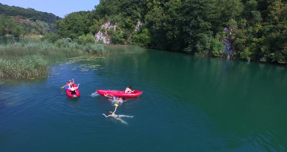 Friends having fun in canoe on Mreznica river, Croatia