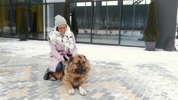 Woman Walking Cute Dog Outdoors on Winter Day