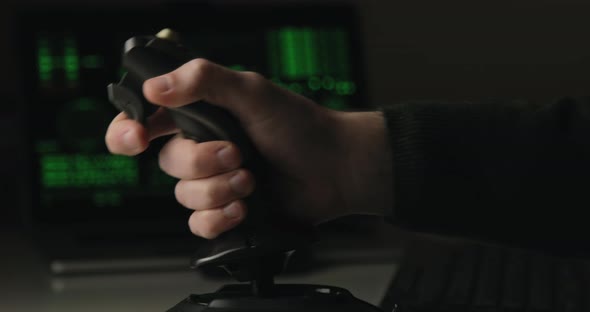 Hand of a Military Pilot Controls a Remote Spy Surveillance Drone for Warfare