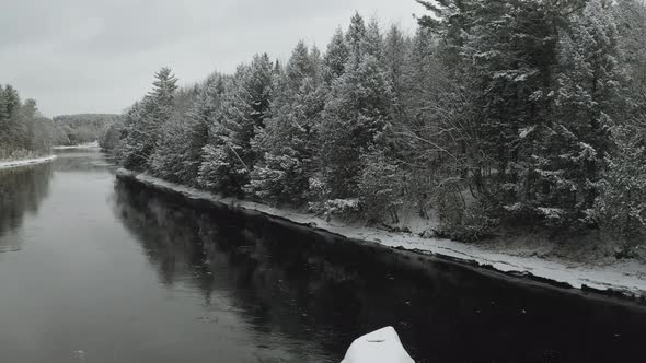 Ice on banks along Piscataquis river. Maine. USA. Aerial dolly out