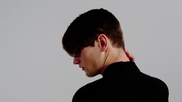 Androgynous man posing against grey background