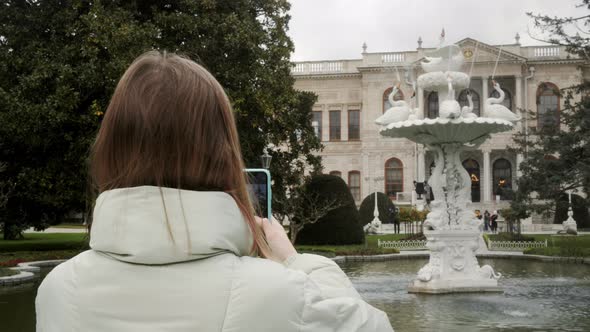 Tourist Girl Photographing Ancient Fountain on Background Dolmabahce Palace in Turkey National