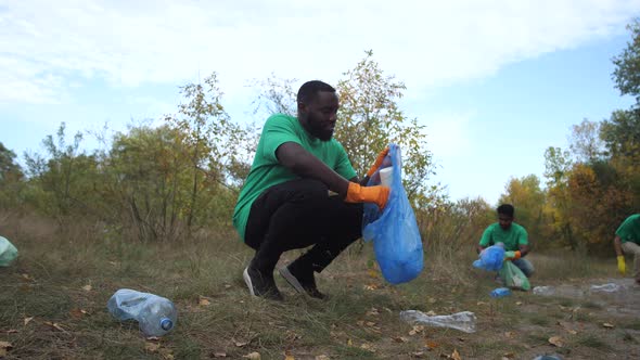 Diverse People Picking Up Plastic Trash in Nature