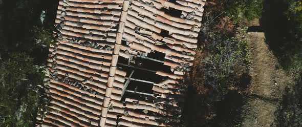 Man looking through broken roof, top down