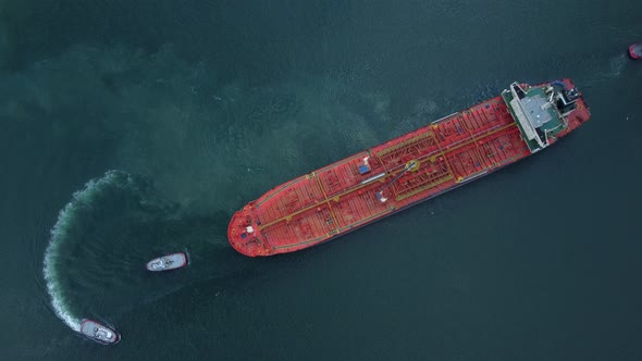 Aerial View of Tanker Ship with Escorting Tug Leaving Port