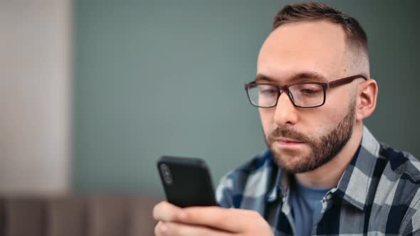Closeup Trendy Handsome Guy Typing Message on Telephone