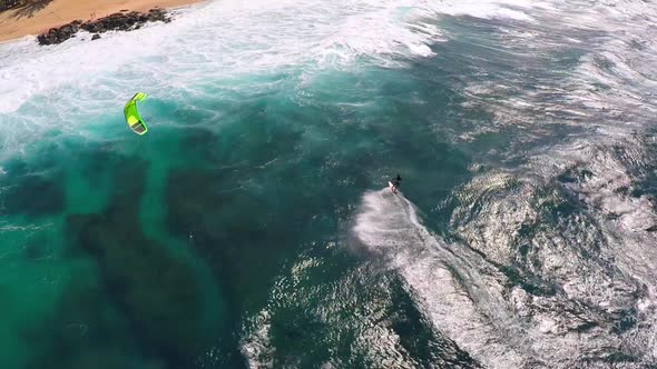 Aerial view of a man kitesurfing in Hawaii