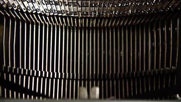 Mechanism of a retro typewriter. Old typewriter hammers. Close up.