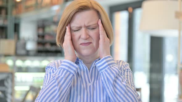 Portrait of Stressed Creative Old Woman Having Headache