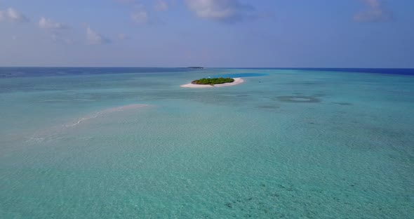 Tropical above island view of a sandy white paradise beach and blue ocean background in colourful 4K