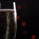 Glass of Champagne Slowly Spinning on a Black Background with Flashing Lights - VideoHive Item for Sale