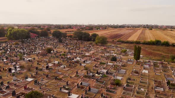 Aerial drone footage of the cemetery by the village. The sunny day above local village cemetery. alt