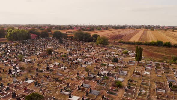 Aerial drone footage of the cemetery by the village. The sunny day above local village cemetery.