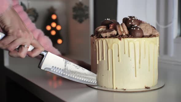 The Girl Cuts Her Freshly Baked Cake in White Icing