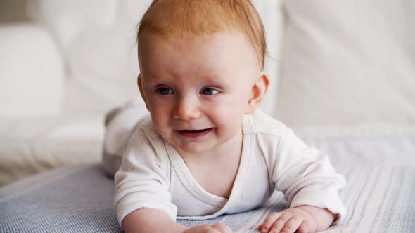 Happy Joyful Red Haired Baby Trying To Crawl