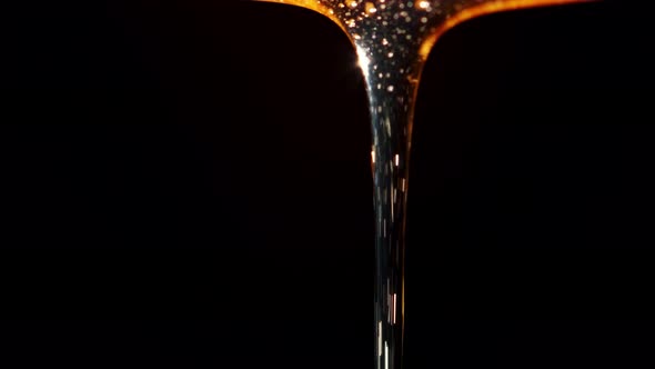Macro Shoot of Thick Liquid Drop of Oil or Honey Falling Over Black Background