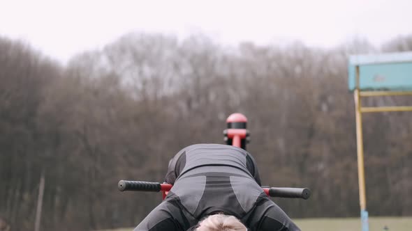 The Sporty Woman in a Protective Mask Is Doing Workout in a Park