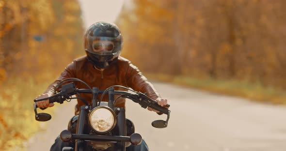 Man Rides a Cruel Motorcycle in a Helmet and Glasses on the Highway